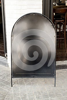 Blank black iron menu board with clipping path front of cafe