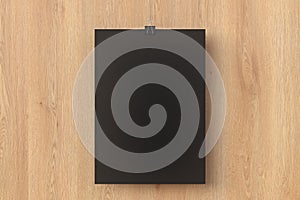 Blank black paper poster hanging on binder clip