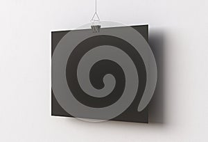 Blank black paper poster hanging on binder clip