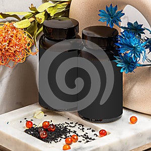 Blank black plastic jar with red caraway oil capsules and black seeds in bathroom