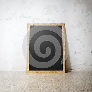 Blank black wooden natural frame on a cocrete wall