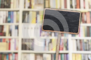 Blank blackboard label and blurred library in the background