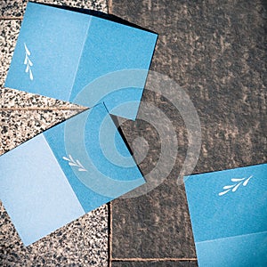 Blank blue cards on grey texture to replace your design, square photo