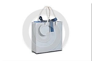 Blank blue paper gift bag mock up standing on a wooden table. Em