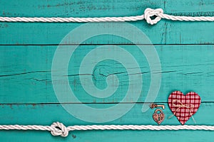 Blank blue sign with white rope border, red heart, bronze key and lock