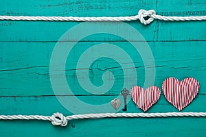 Blank blue wood sign with hearts, key and lock by rope with knots border