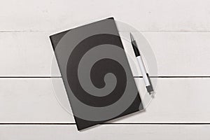 Blank book cover template with page in front side standing on white wood background