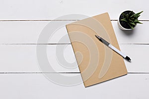 Blank book cover template with page in front side standing on white wood background