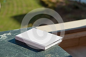 blank book mockup on green marble stone coffee table , shadow overlay