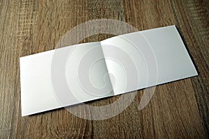 Blank booklet mockup on wooden background