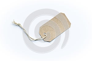 Blank brown cardboard price tag or label tag with thread isolated on white background