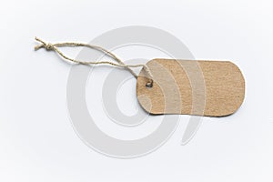 Blank brown cardboard price tag or label tag with thread isolated on white background