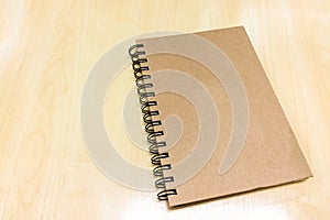 Blank Brown Cover Book on Wooden Table at Corner used as Template