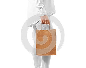 Blank brown craft paper bag design mockup holding hand