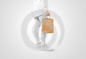 Blank brown craft paper bag design mockup holding hand