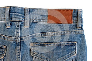 Blank brown leather label sewed on a blue jeans.