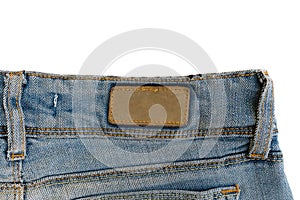 Blank brown leather label sewed on a blue jeans.