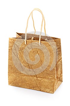 Blank brown nacre gift bag with raised handles. Isolated on a white background.