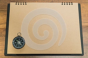 Blank brown paper with black compass on top