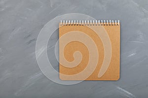 Blank  brown spiral notebook cardboard sheet on grey background. Retro  old vintage beige paper. Design element  copy space