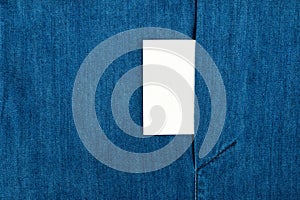 Blank business card with copy space in a pocket of blue jean jacket.