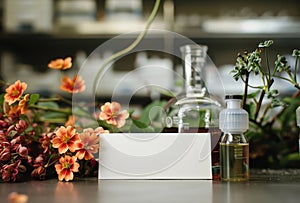 Blank business card and perfume bottles on the table with flowers