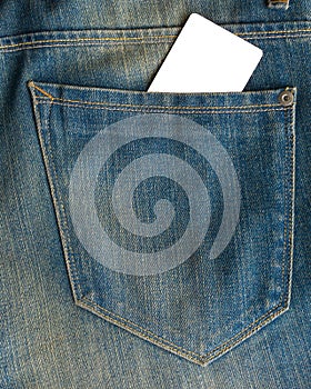 Blank business card in a pocket of blue worn out jeans.