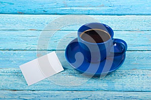 Blank business cards, blue cup on the wooden table. Office desk tabl. Template for ID. Top view. A cup of coffee.