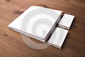 Blank business cards and booklet, brochure on a wooden background.