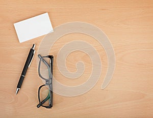 Blank business cards with pen and glasses