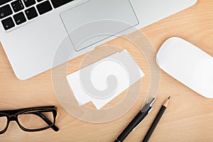 Blank business cards on wooden office table