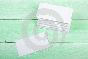 Blank business cards on the wooden table. Template for ID. Top view. Office desk tabl