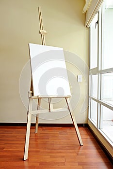 Blank canvas on a wooden tripod in the studio