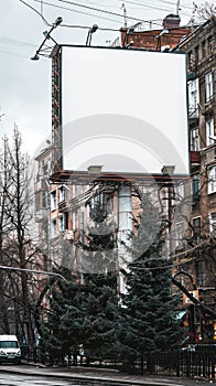 Empty Urban Billboard Surrounded by Trees and Buildings, Ready for Advertising and Creative Design, Amidst Cityscape, Overcast photo