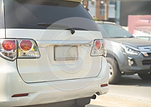 Blank car number plate on white suv back view