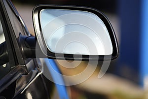 blank car rearview mirror with copy space on a blurred background