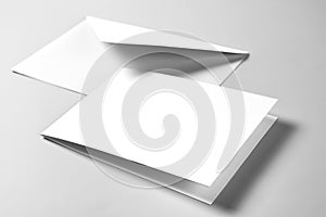 Blank card and envelope over grey background
