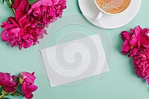 Blank card mock-up on the table with beautiful peonies and cup of coffee