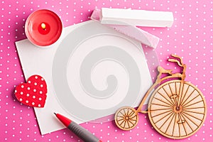 Blank card on pink polka dot background with bike