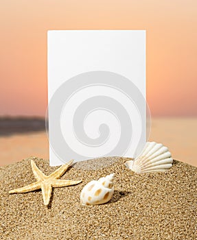 Blank card on sand beach with sea shells