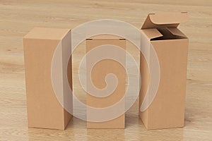 Blank cardboard tall and slim gift box with open and closed hinged flap lid on wooden background.