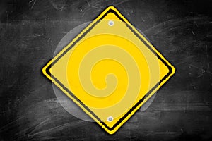 Blank caution sign on a black chalkboard