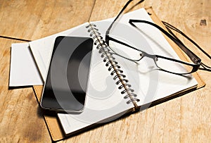Blank cell phone diary and glasses