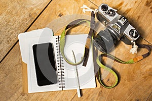 Blank cell phone, diary and old photo camera