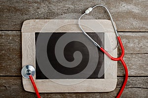 Blank chalkboard, stethoscope, health background concepts.