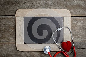 Blank chalkboard, stethoscope and red heart, health background c