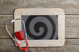 Blank chalkboard, stethoscope and red heart, health background c