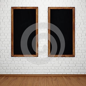 Blank chalkboard on white brick wall