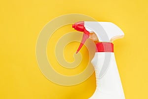 blank chemical spray bottle on a bright yellow background. copy space. cleaning and washing concept