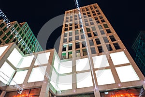 Blank citylight for advertising on the building at city night, copyspace for your text, image, design